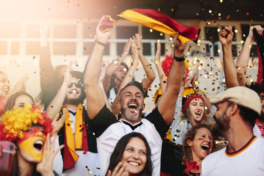 group,of,man,and,woman,cheering,their,national,team.,german